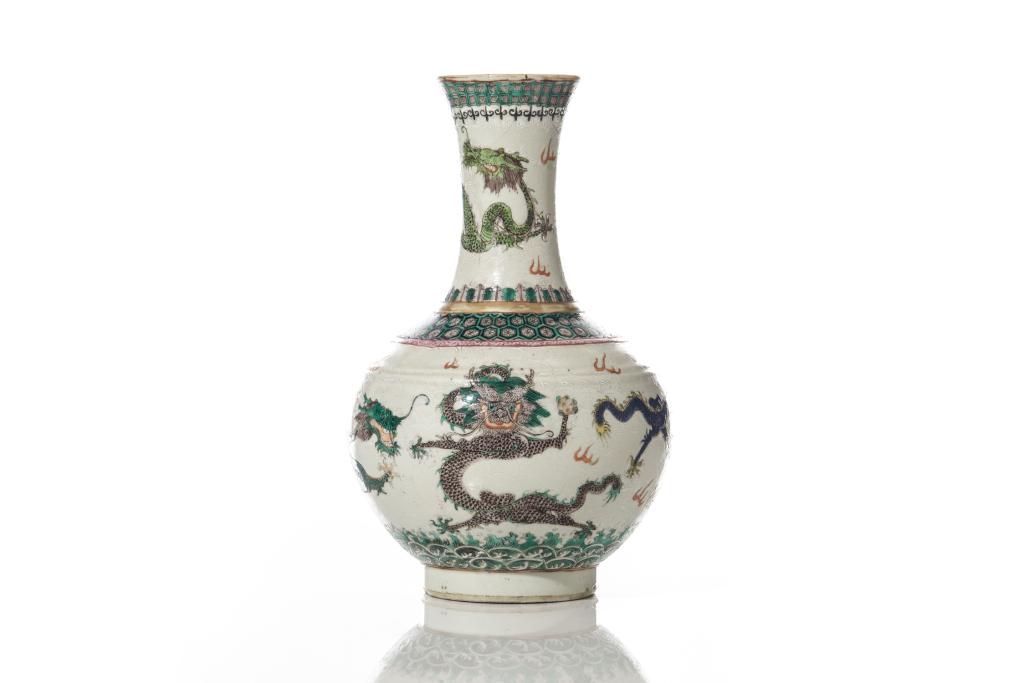 SGRAFFITO FAMILLE ROSE PORCELAIN DRAGON VASE: Painted with green, yellow, blue, and aubergine glazed dragons against sgraffito wave grounds, and two dragons to bottom framing the mark. Lappets and geometric blands to rim and neck. Wave bands to f