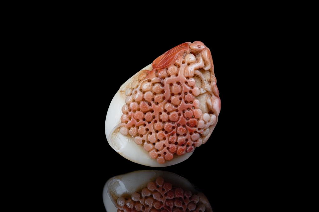 CHINESE SOAPSTONE CARVED SQUIRREL AND GRAPES: White stone with red inclusions. Carved as a squirrel and monkey among grape vines. H. 5cm (2 in.)