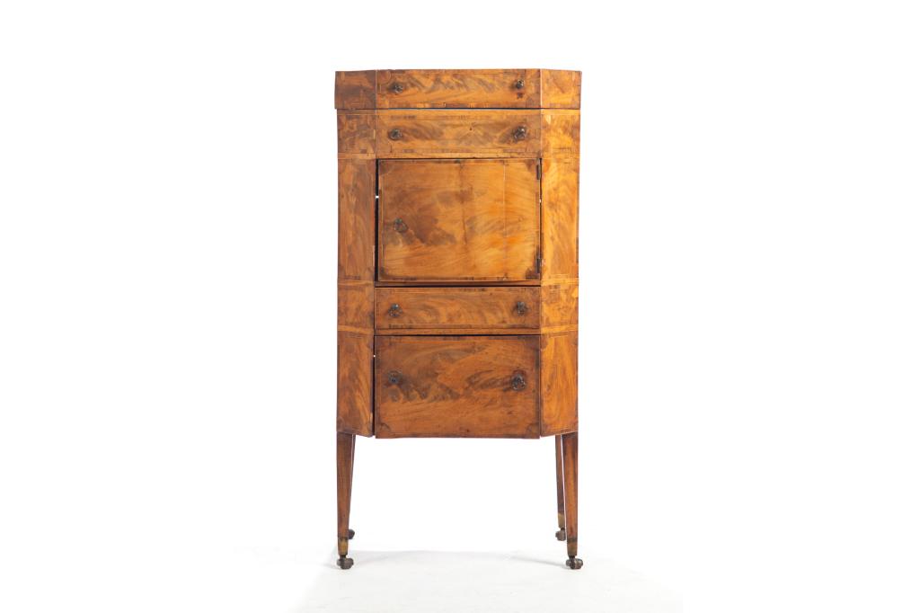 GEORGIAN FLAME MAHOGANY STANDING CELLARETTE: Fitted with two drawers, a cupboard, and a hinged top opening to reveal an interior cellarette carcass. With canted inlaid corners, original pulls and feet. H. 37 1/4 W. 18 D. 17 1/4 in. Condition not