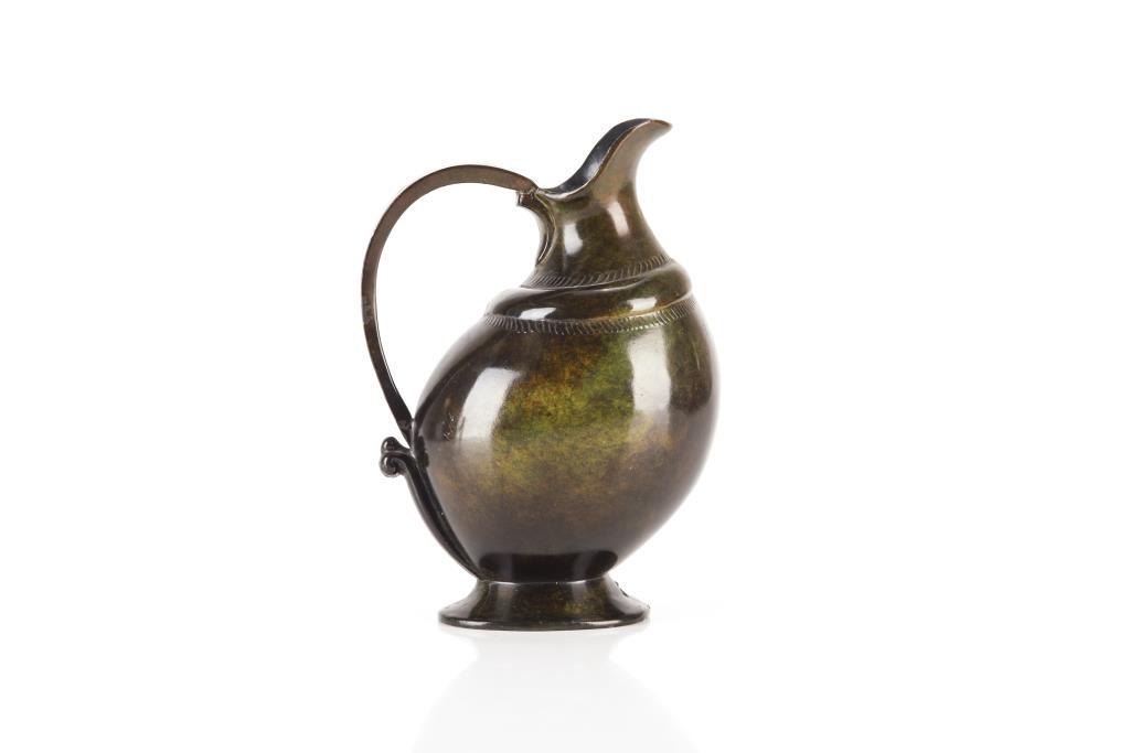 SCANDINAVIAN BRONZE EWER: Green patinated jug, stylized with a fish swimming around the body, early 20th C. H. 17.8cm (7in)