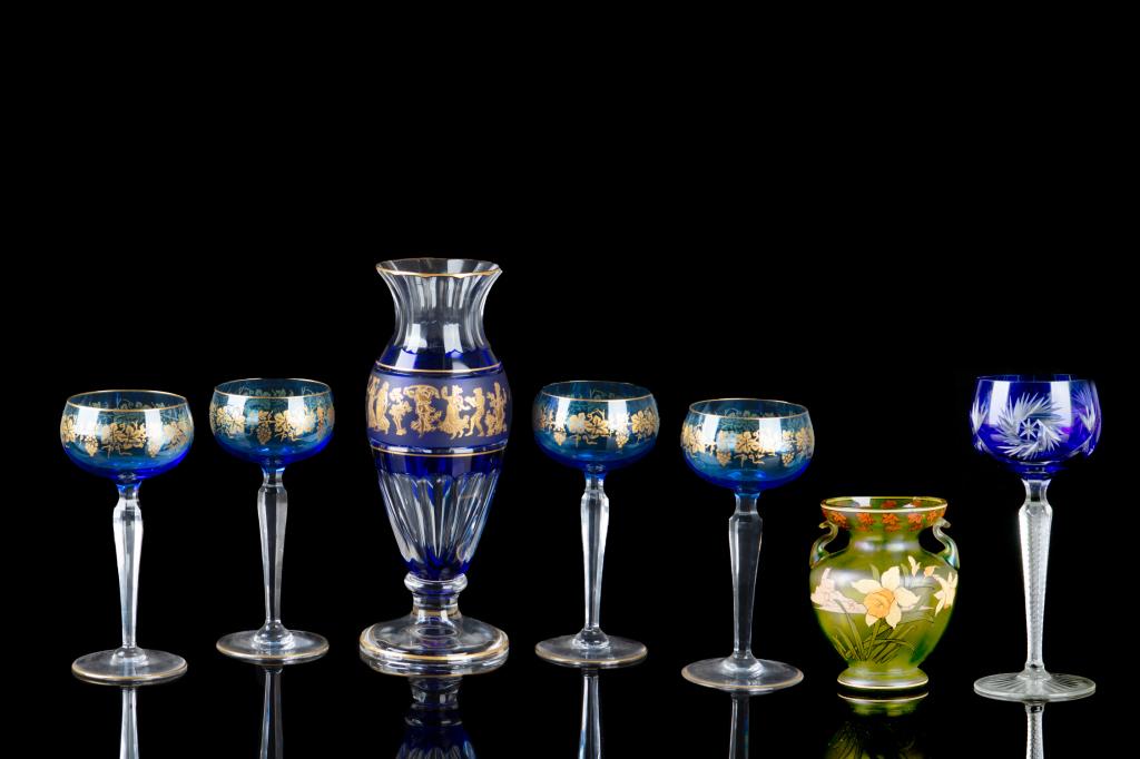GROUP OF VAL ST LAMBERT GLASS TABLE ACCESSORIES: French crystal, collection includes: - One cobalt Danse De Flore Vase, with gilded Grecian style figures, with maker name on bottom - Four cobalt blue Saumur wine stems with gilded leaf and grape deco
