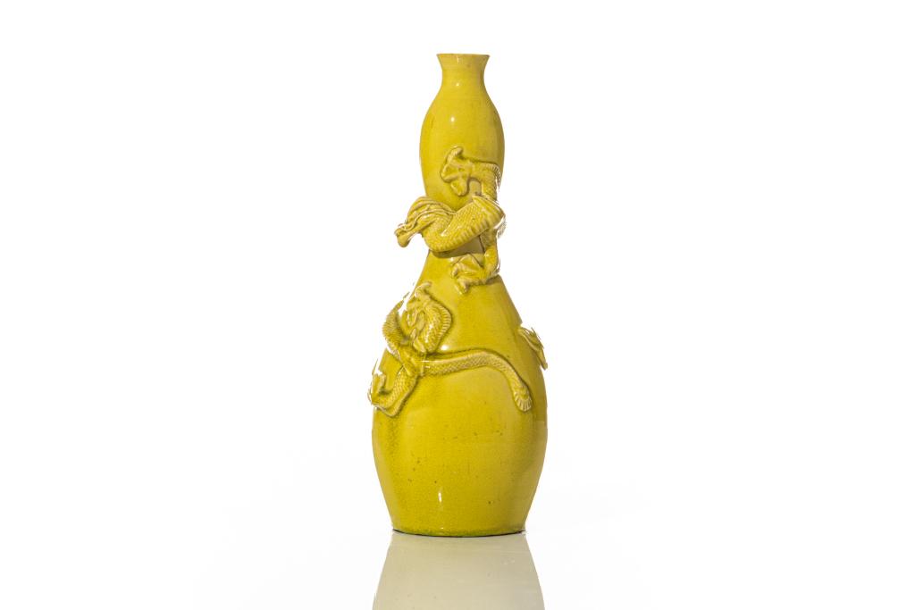 YELLOW GLAZED PORCELAIN VASE WITH DRAGONS: Double gourd form vase applied with relief dragons and cloud to exterior. 19th C. H. 24cm (9 1/2 in.)