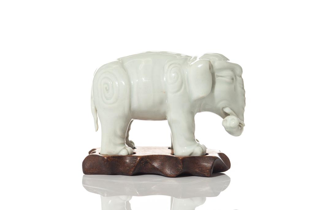 CHINESE WHITE GLAZED PORCELAIN ELEPHANT FIGURE: With fitted wood stand. L. 12cm (4 3/4 in.)