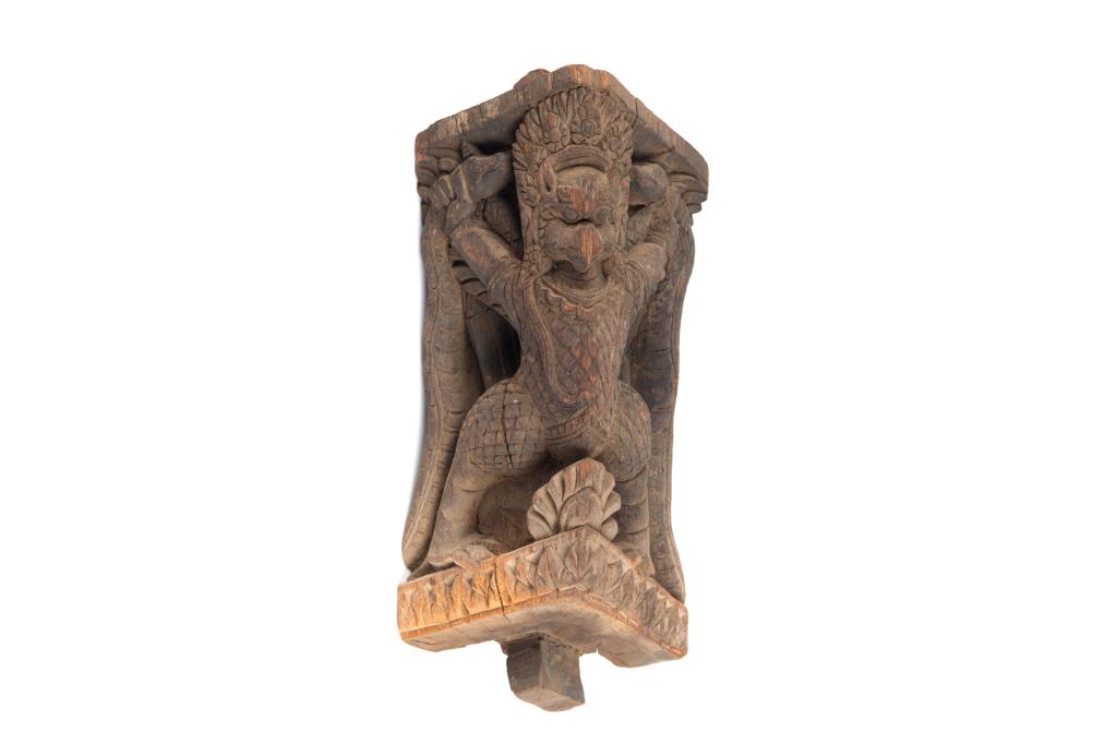 18TH C. NEPAL WOOD GARUDA STRUT FROM A TEMPLE: Carved in high relief with a garuda figure in a standing position with open arms and holding two serpents. 18th C. H. 32cm (12 1/2 in.)