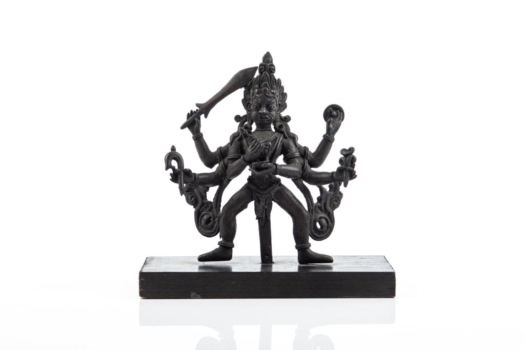 19TH C. NEPAL BRONZE FIGURE OF SHIVA ON WOOD BASE: Six armed figure holding an implement in each hand. H. of bronze figure: 15cm (6 in.)
