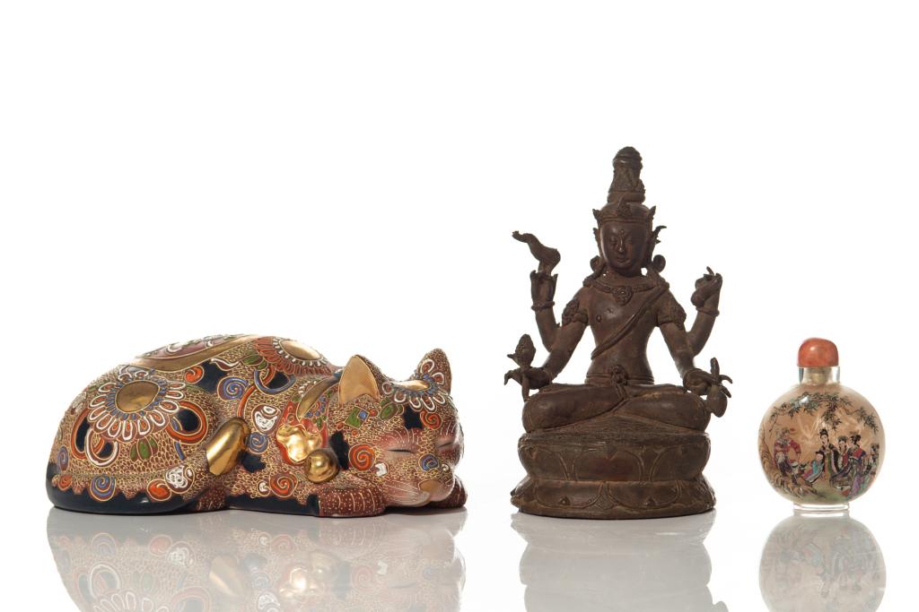 GROUP OF THREE ASIAN ANTIQUES: Including a four-armed Buddhist statue, a Chinese inside painted snuff bottle, and a Japanese Moriage porcelain cat. L. of cat: 21cm (8 1/4 in.)