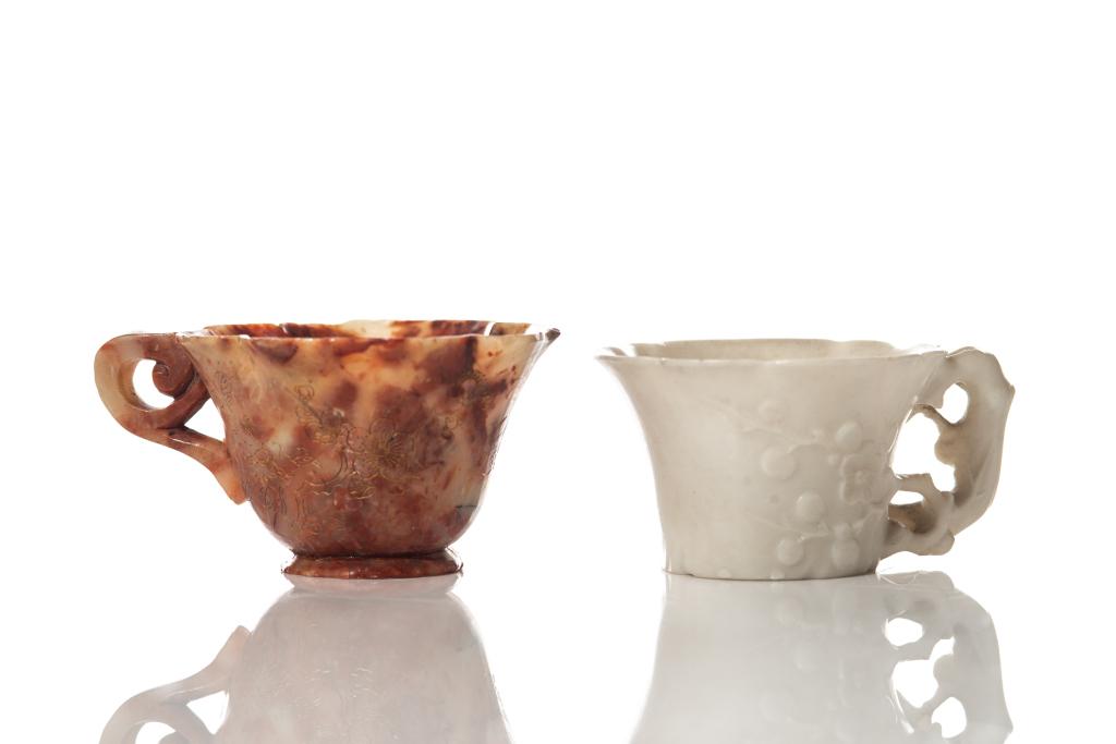 TWO CHINESE SOAPSTONE CARVED CUPS: Including one white cup and one chicken blood type cup. H. of largest 4.25 cm (1 5/8 in)