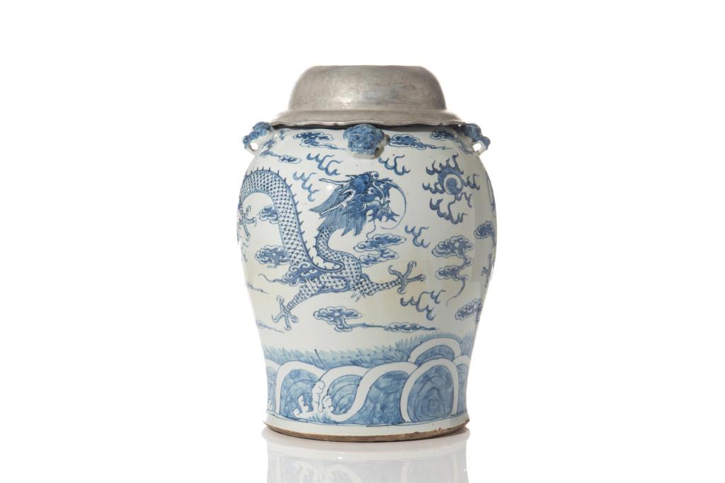 LARGE CHINESE BLUE & WHITE PORCELAIN DRAGON JAR: Blue and white jar painted with dragons chasing a flaming pearl amongst clouds. With four blue mask handles and metal top. H. 51cm (1 ft. 20 1/4 in.) Dia. 16cm (6 1/4 in.)