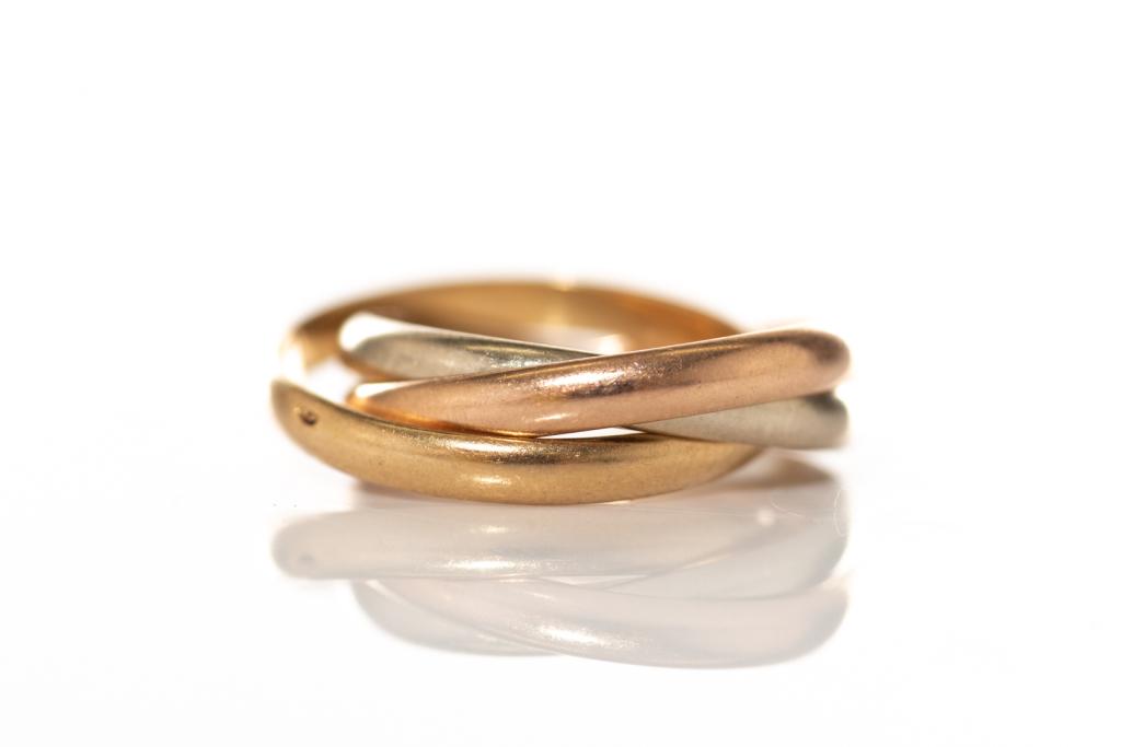 CARTIER TRINITY RING: 18k yellow, rose, and white gold Cartier trinity ring. Stamped 18k. Trademarked "Cartier". Size 5.75-6 (EU52) Weight: 4.9g