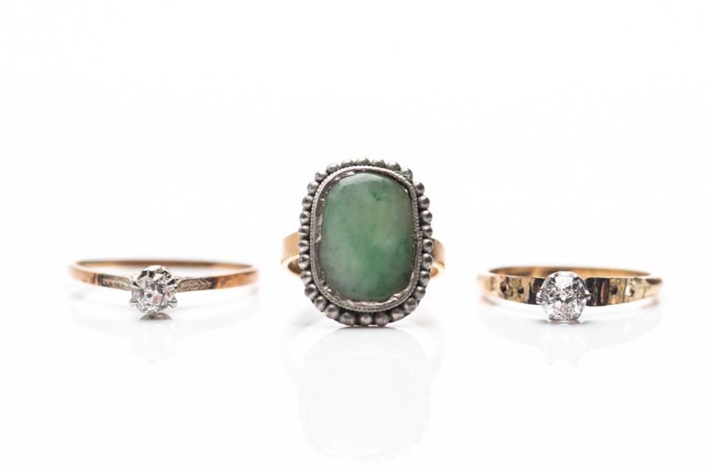THREE ANTIQUE RINGS: Including a jadeite vintage ring and two small diamond rings.