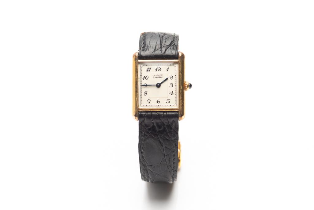 CARTIER LADIES TANK WRISTWATCH: Sterling silver and gold plated Cartier wristwatch stamped on reverse with "Vermeil Tank Quartz, Argent 925". Creme rectangular dial with Arabic numerals, attached black leather strap with gold plated