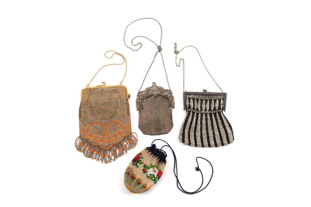 GROUP OF FOUR ANTIQUE PURSES: Three beaded purses, one with drawstring closure and the other two with clasps and small chain handle. Orange beaded purse features a silk lining and small matching mirror inside, made in France. The 