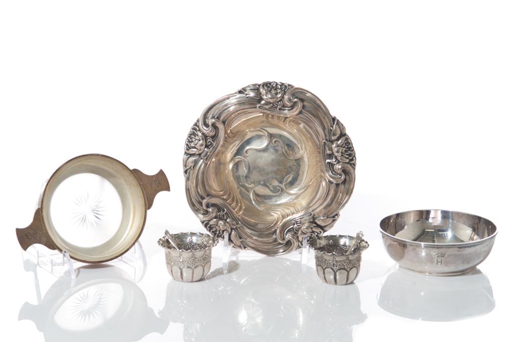 FIVE AMERICAN & ENGLISH SILVER TABLE ACCESSORIES: Including the following: an Art Nouveau English silver dish with decorative flowers in high relief along the rim, by Whiting; an English silver and frosted glass two handled butter dish, Stokes &Irela