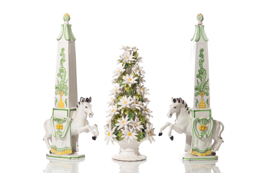 THREE ITALIAN MAJOLICA PORCELAIN PIECES: Including two painted columns with horses, made for Meiselman Imports as inscribed on underside, and a painted floral centerpiece with daisies. Mid- 20th C. H. of tallest 62 cm (24 3/8 in)