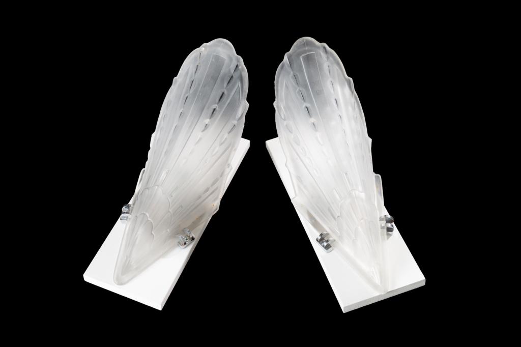 PAIR OF ART DECO SLIP SHADE WALL SCONCES: Glass shades repurposed to form sconces, likely previously from a chandlier. Both mounted on white plywood backing, with single bulb fixtures in each. H. of each shade approx. 35 cm (13 3/4 in) Condit
