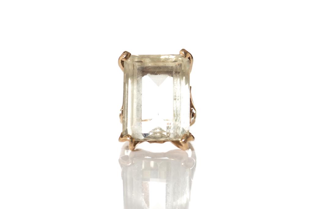 GOLD CITRINE COCKTAIL RING, 9.5g: Yellow gold ring with decorative openwork shoulders and rectangular prong setting. Large rectangular faceted citrine quartz solitaire, measuring approx. 20 x 15 x 9.5 mm, weighing approx. 21cts by gau