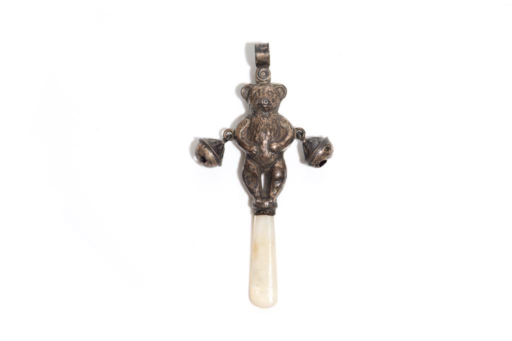 ENGLISH EDWARDIAN SILVER NOVELTY BABY RATTLE: Shaped as a bear, with two bells and mother of pearl handle. Makers mark C&N Birmingham H. 10 cm (4 in)