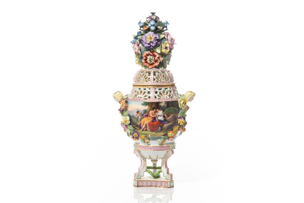 DRESDEN CARL THIEME PIERCED POT POURRI JAR: Saxonian porcelain, 20th century. With applied floral decoration and figural handles and gilded detailing, with painted figures in a landscape scene on one side of the body. With pink mounts and serpe