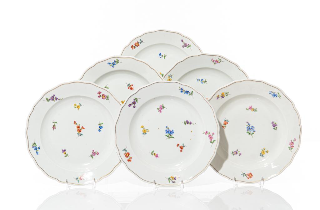 GROUP OF SIX MEISSEN FLORAL PAINTED DINNER DISHES: German, 20th century. White ground with delicate hand painted flowers and gilded border around edge. Double crossed sword stamp mark on the underside of each plate. Dia. 25 cm (9 7/8 in)