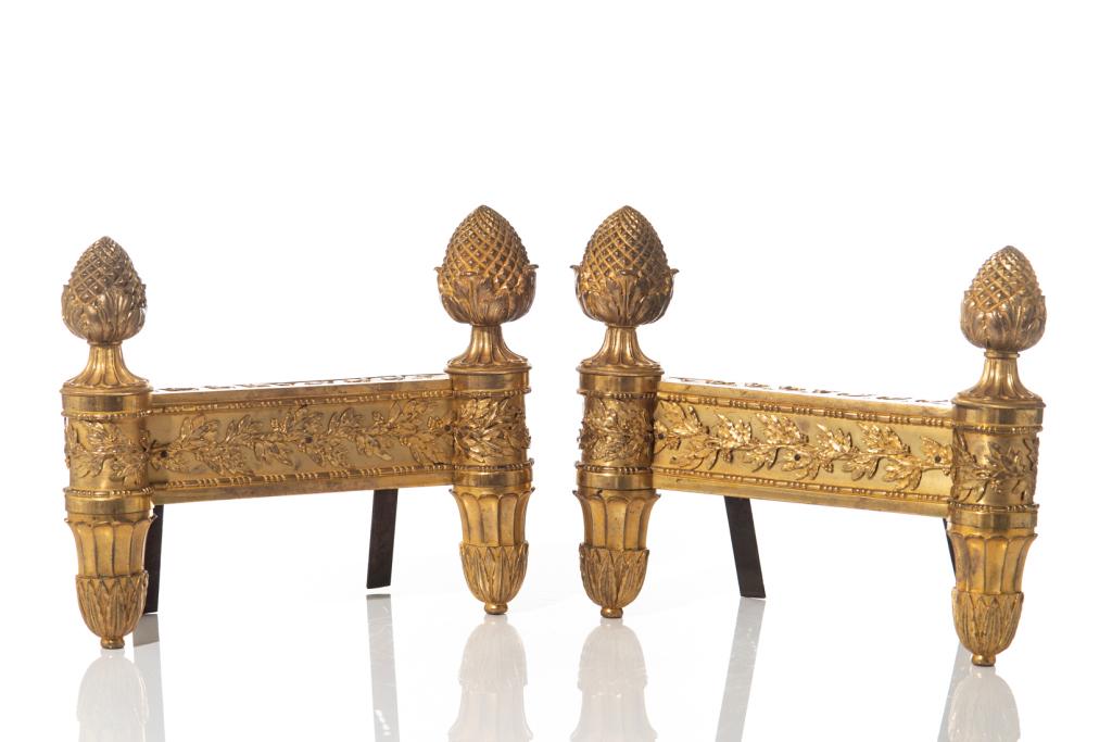 PAIR OF ORMOLU GILT BRONZE CLASSICAL CHENETS: With applied foliate mounts and pinecone finials. 19th C. H. 30 cm (11 3/4 in.) L. 35 cm (13 3/4 in.)