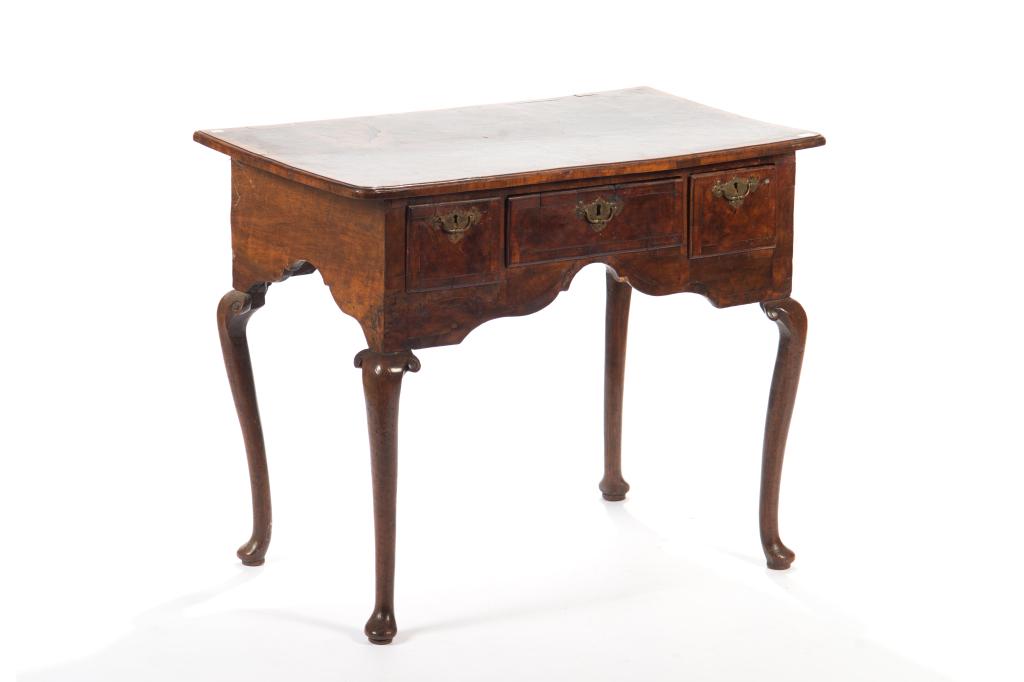 GEORGE II MAHOGANY AND BURLED WALNUT LOWBOY: Burled top with traditional queen ann feet and brass pulls. H. 28 3/4. W. 35. D. 21 1/2 in.