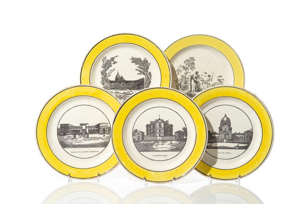 GROUP OF FIVE EARLY TRANSFERWARE DISHES: Series of French earthenware plates with yellow borders framed in black. Four with an interior transfer print scene of a Paris landmark and one with an allegorical scene. No maker's mark. Late 18-earl
