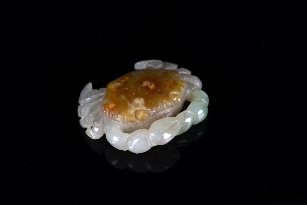 CHINESE JADEITE CARVING OF A CRAB: Overall in light gray tone with apple green inclusions to left craw and russet brown inclusion to back. W. 5cm (2 in.) Condition report available upon request.