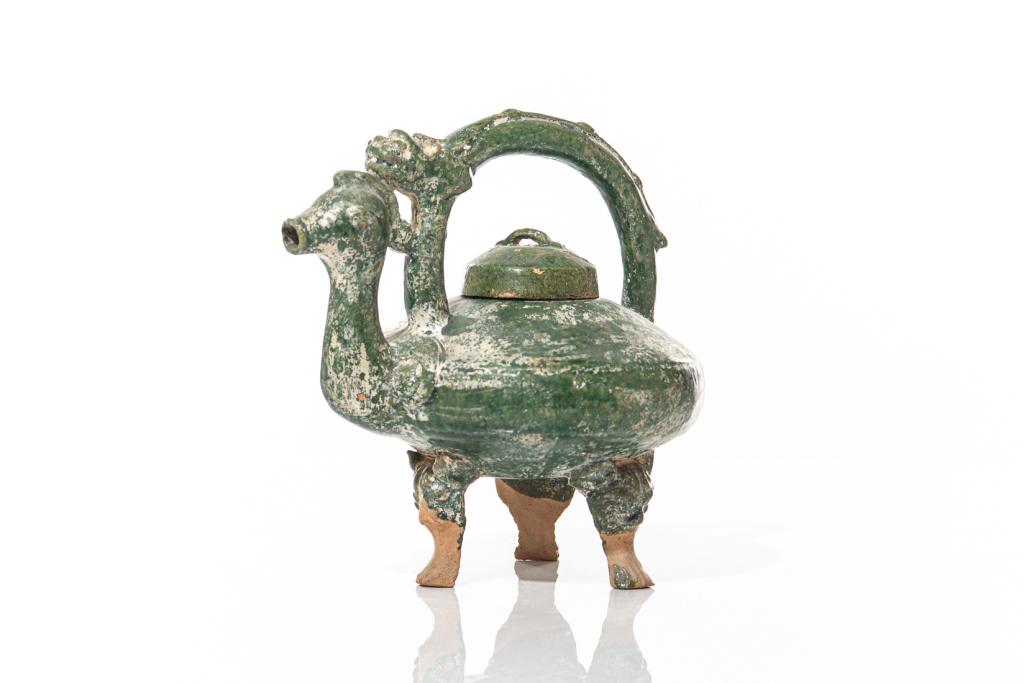 CHINESE GREEN GLAZED CHICKEN HEAD EWER: Bronze imitation glaze tripod wine ewer (he) with upright handles and chicken head spout. Possibly Han dynasty. H. 9cm (7 1/2 in.)