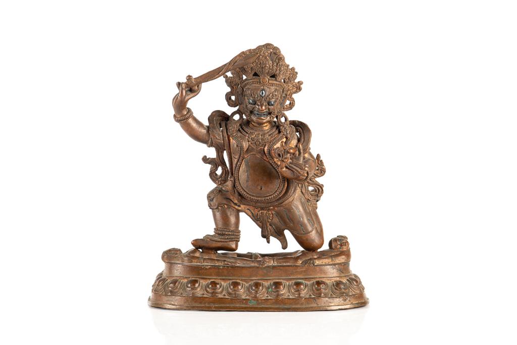 19TH C. TIBETAN SILVER INLAY BRONZE WRATHFUL DEITY: Supported on a lotus base with two supine figures. Each hand holding an implement, furious facial expression with month opened. Silver inlaid eyes, teeth, and tiger stripes. With consecration intact o