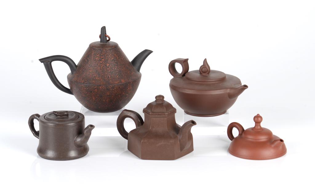 FIVE ASSORTED CHINESE YIXING POTTERY ZISHA TEAPOTS: Largest pot dimensions: H: 15cm (6 in.) L: 19cm (7 1/2 in.) Condition report available upon request.