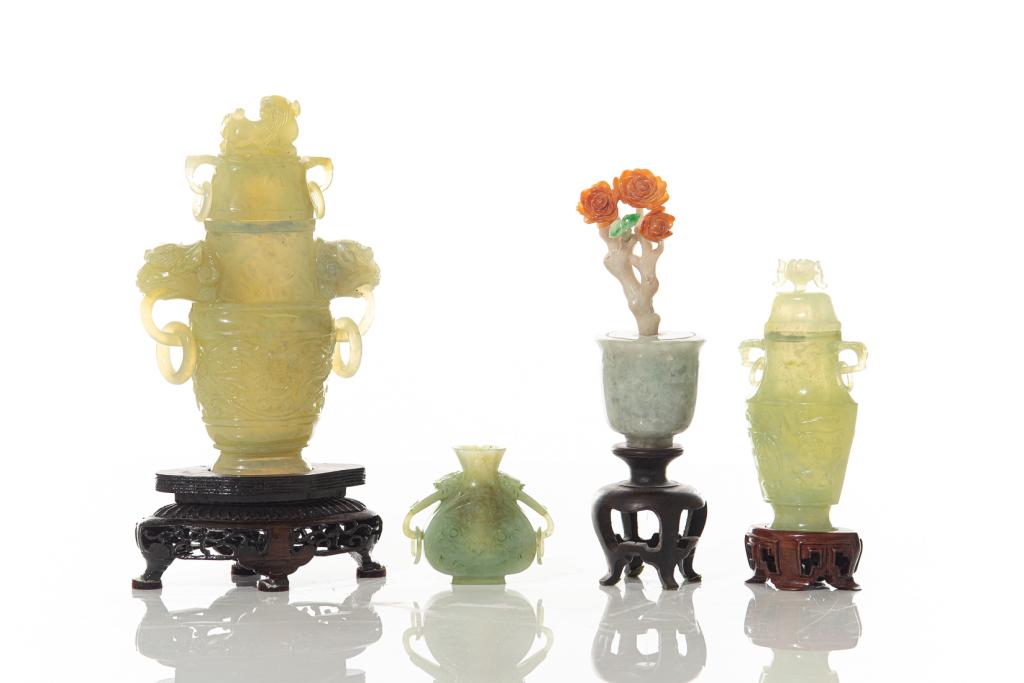 GROUP OF FOUR CHINESE JADE CARVINGS: Including three celadon jade ornamental vases with loose rings, and one jadeite flower pot with orange and apple green inclusions. Tallest on stand: 21.5cm 8 1/2 in.) Condition reportavailable upon re