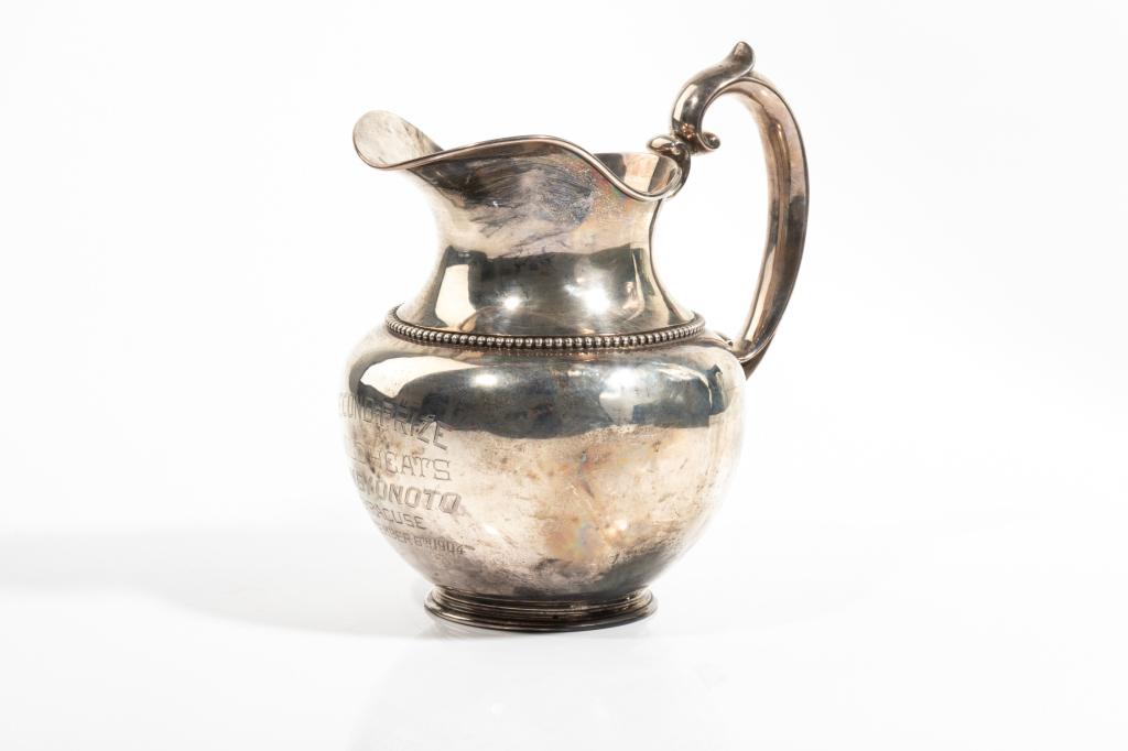 AMERICAN SILVER PRESENTATION WATER JUG, 504g: Bulbous form with beaded trim around the shoulder of the pitcher. By M. J. Rowe, pattern 606, 3 1/2pts. Engraved presentation "Second Price 1/2 Mile Heats Won By Onoto, Syracuse, September 8th,1904." 