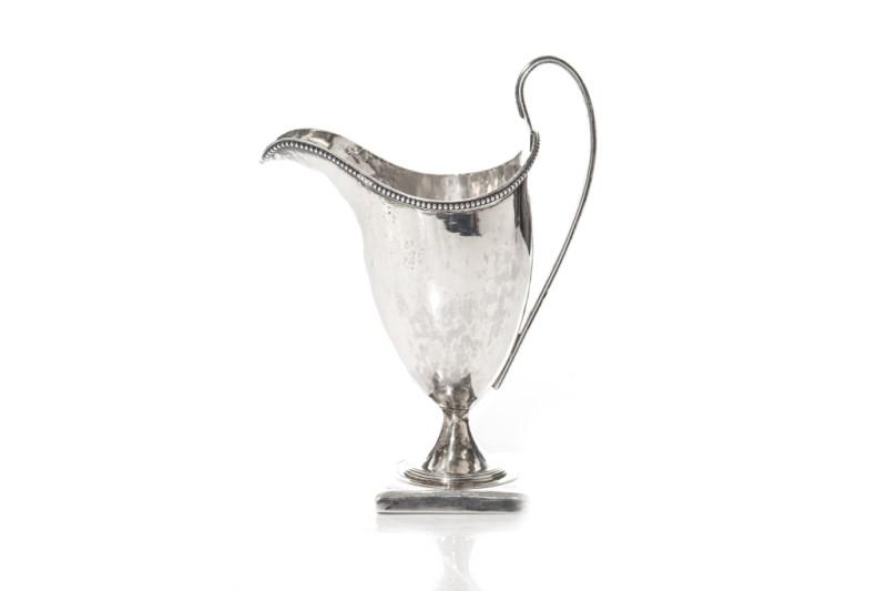 GEORGE III SILVER HELMUT CREAMER, 109g: A Georgian sterling silver creamer with a beaded rim and on a square foot. George Gray struck over Peter & Ann Bateman, London, 1794. H. 14.6cm (5 3/4 in.)Weight: 109g