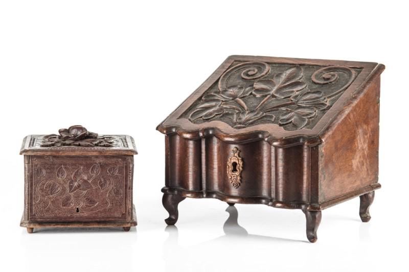 BLACK FOREST CARVED WOOD LETTER BOX AND HUMIDOR: Antique, both have ornate foliate carving, likely from oak. Letter box includes a brass key hole, slanted top and raised on feet, H. 25 cm (9 7/8 in). Cigar case includes small dividing shelves stacke