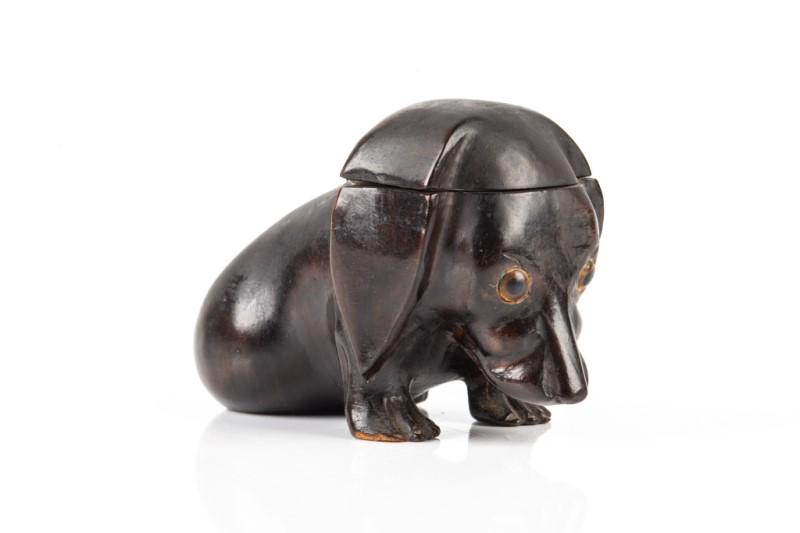 CARVED DOG INKWELL: Likely Bavarian, black forest style with beaded eyes. Head opens up to porcelain inkwell insert. H. 7.5 cm (3 in)
