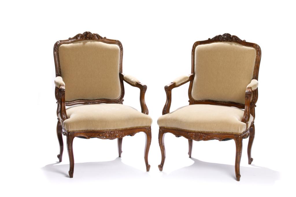 PAIR OF FRENCH CARVED WOOD FRAMED BERGERE CHAIRS: With taupe mohair upholstery and brass studded details. H. 40 1/2 W. 28 D. 22 in.