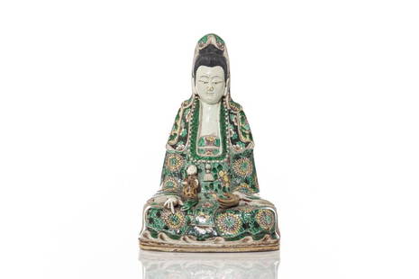 CHINESE FAMILLE VERTE BISCUIT PORCELAIN GUANYIN: 清康熙 素三彩觀音 Guanyin seated, wearing a long robe and holding a cup in one hand. Qing dynasty, Kangxi period, 18th C. H. 24.1cm (9 1/2 in.) 