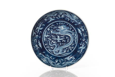 CHINESE BLUE GROUND PORCELAIN DRAGON DISH: 清康熙款 青花留白龍紋盤 Painted on both sides with a total of five five-clawed dragons writhing amidst clouds and flames in pursuit