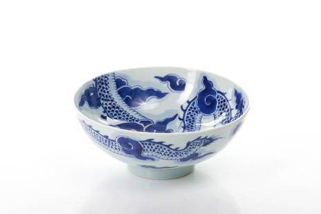 CHINESE BLUE & WHITE PORCELAIN DRAGON BOWL: 清雍正 青花過墻龍紋碗 The porcelain bowl painted with a dragon amongst clouds connected on both sides. Six character Yongzheng mark to