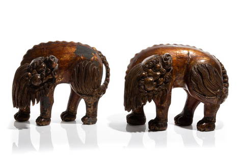 PAIR OF CHINESE GILT & LACQUERED WOOD LIONS: 清 金漆木雕獅子（一對）Gold and red lacquered body carved as a lion with head turned. Qing dynasty. H. 26cm (10 1/4 in.)