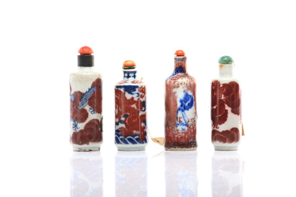FOUR COPPER RED, BLUE & WHITE SNUFF BOTTLES: 清 青花釉裡紅瓷鼻煙壺（四個）One of a copper red only bottle, three with copper red and underglaze cobalt blue. All