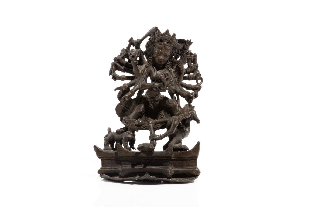 18TH C. NEPAL BRONZE DURGA SLAYING BULL DEMON: 十八世紀 尼泊爾突迦銅像 Cast as the multi armed Durga conquering Mahishasura the bull demon, accompanied by lion. H. 19cm (7 1/2 in.)
