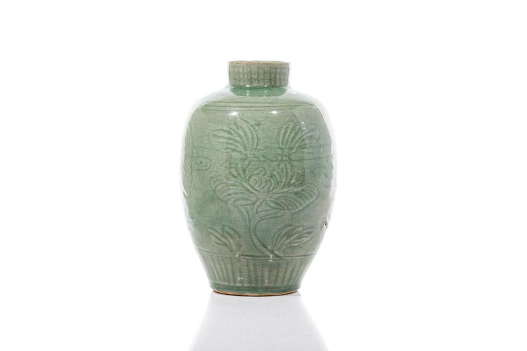 CHINESE LONGQUAN CELADON CARVED JAR: 明 龍泉青瓷花卉紋罐 Carved floral patterns to body with lappet bands. Ming dynasty. H. 27cm (10 5/8 in.) Provenance: See Lot 1074 note, an importa