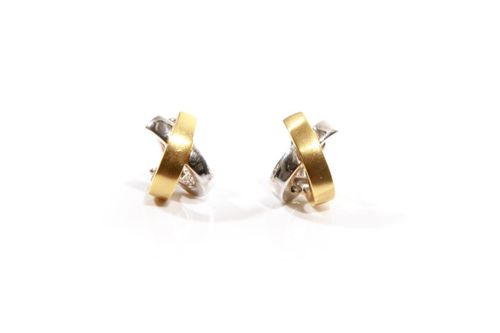 PAIR OF ITALIAN GOLD EARRINGS, 9g: Pair of yellow and white gold crisscross band earrings. With omega back closure. Stamped 14k and "Italy'. 9g.