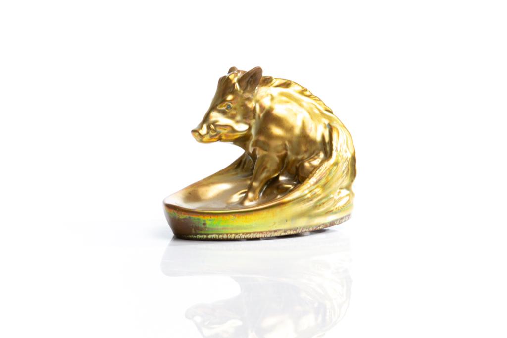 ZSOLNAY EOSIN LUSTRE GLAZED FIGURAL VIDE POCHE: Hungary 20th century, hand painted pottery oval dish depicting a boar in iridescent gold tone. Makers mark on the underside. H. 11.5 cm (4 1/2 in) W. 16 cm (6 3/8 in)