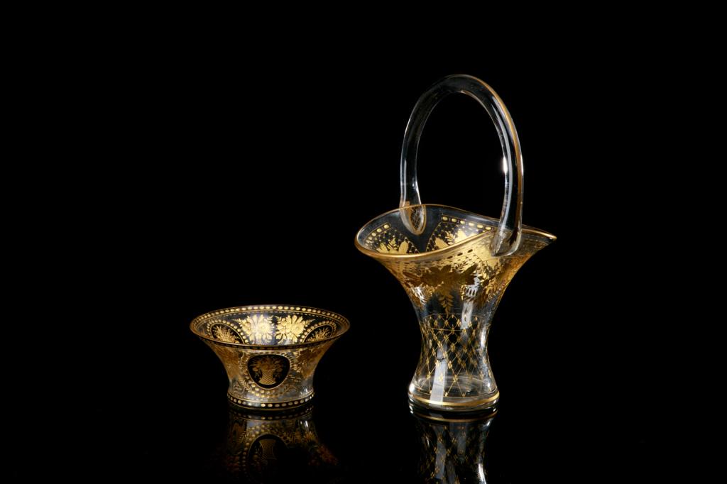 TWO PIECES OF BOHEMIAN ETCHED GLASS: Including one flared bowl and basket form vase with handle. Both with clear glass and gilded floral bouquets.H. of largest 33 cm (13 in)