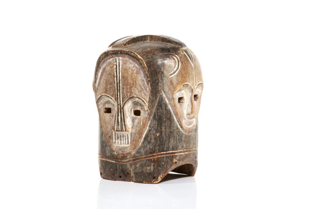 AFRICAN FANG NGONTANG HELMET MASK: Gabon / Central Africa, Betsi or Ntumu group. Four faces surround the helmet on all sides, with eyes looking out from all sides. Faces on opposing sides bear similar resemblance - and each face featur