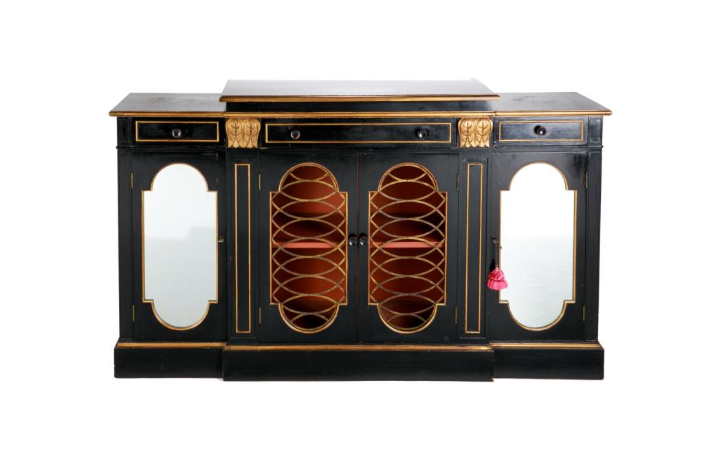 VINTAGE EBONIZED SERVER BUFFET: Vintage ebonized server buffet with gilded accents, and mirrored doors flanking a pair of wire-work doors. c 1940. H. 36 1/2 W. 62 D. 15 1/2Wear to top.