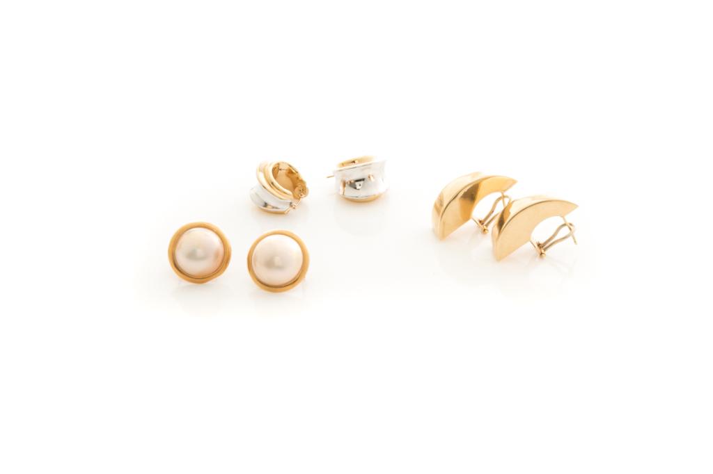 THREE PAIRS OF GOLD EARRINGS, 18g: One pair of two-tone gold earrings testing 14k; one pair of stylized half hoop earrings with omega back closures, testing 14k together with a pair of pearl earrings; and one pair of gold and mabe pear