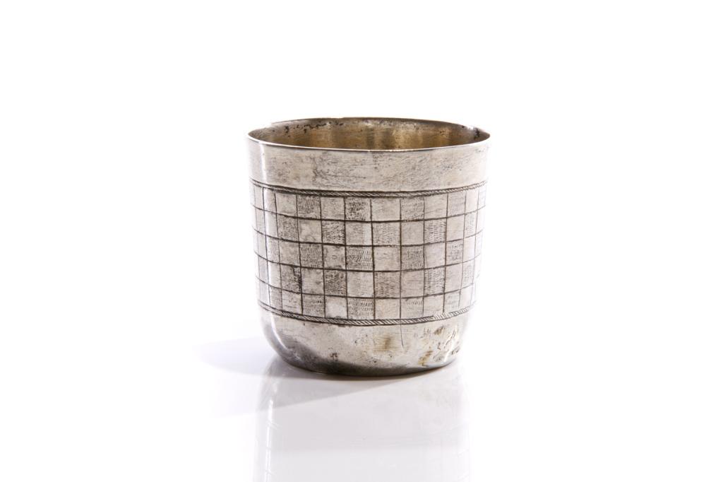 18TH C GERMAN PROVINCIAL SILVER BEAKER, 50g: In traditional form with an engraved checkered pattern. Hallmarked to base, maker's mark is either WS or MS. H. 5 cm (2 in.)